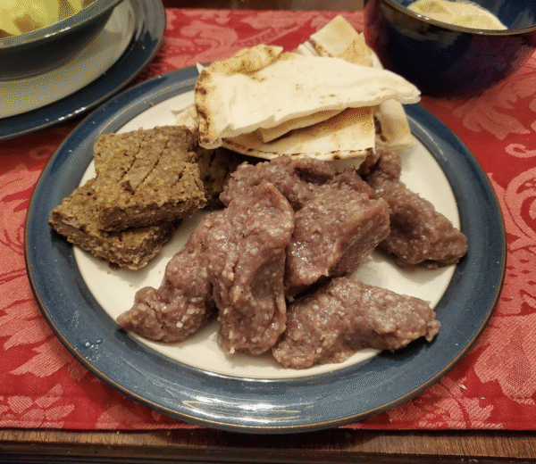 Traditional cooked kibbey squares and kibbey nayye hand balls.